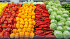 A colorful array of vegetables in a produce aisle of a grocery store