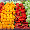 A colorful array of vegetables in a produce aisle of a grocery store