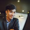 Man smiling and working on laptop