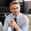 Man in business attire sitting in an office