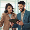 Coworkers discussing content federation on tablet in office setting