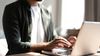 A person enters their information on a laptop to watch an on-demand webinar.