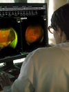 A healthcare professional uses Hyland Healthcare medical imaging products on a desktop computer.