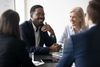 Two Hyland partners collaborate on success strategies at a conference table.