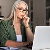 A remote employee sits in a home office and reviews information about data capture on their laptop.