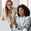 Staff from insurance industry working in front of laptop together