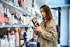 woman checking out beauty products in an aisle