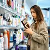 woman checking out beauty products in an aisle