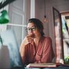 Woman sitting at a desk in a home office.