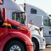 A fleet of cargo trucks parked in parallel.