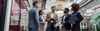 Businesspeople talking while standing in office during break