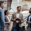 Businesspeople talking while standing in office during break