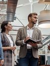 Businesspeople talking while standing in office during break