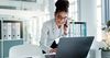 Office worker on laptop and phone