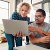 1 person showing her laptop to the other person
