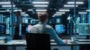 Office scientist working at two monitors in the futuristic laboratory