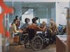 A diverse group of people smiling and talking in an office. One person in a wheelchair is wearing a VR headset on their forehead, pointing while others watch.