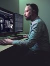 Healthcare professional views medical images on a desktop computer.