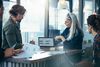 woman and man in office looking at laptop