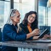 Two women sharing ideas on tablet