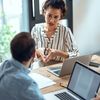 Shot of smart business people working together with laptop while talking in the workplace.