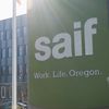 Green SAIF business sign with the company?s tagline, ?Work. Life. Oregon."