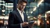 Modern businessman with tablet in business center interior.