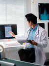 Doctor reading a patient's electronic health record on a monitor