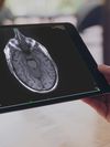 Close-up of a tablet screen with medical imagery on it.