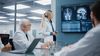 Meeting of medical professionals looking at imaging scans in a healthcare setting