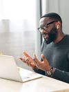Office employee talking via video connection while sitting at the desk