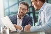 Man with tablet during meeting of business people in office discussion