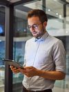 Businessperson reviews process automation capabilities on a tablet.