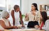 diverse female office coworkers have a discussion