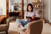woman uses stylus to sign form on tablet