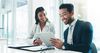 People smiling at tablet in meeting room