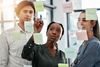 Office team looking at sticky notes
