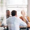 group of 4 people discussing in a meeting