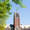 The exterior of John Carroll university, which has red brick and a tower.