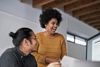 Happy employees laugh together in an office.