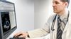 Healthcare professional uses Hyland Healthcare solutions on a desktop computer.
