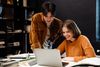 two people discussing and staring at the laptop screen