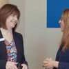 A Civista Bank employee chats with a Hyland Services consultant in a hallway.