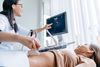 Doctor pointing at computer screen during prenatal ultrasound