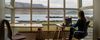 Person works from home overlooking hills and a lake.