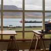 Person works from home overlooking hills and a lake.
