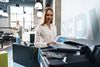 Female office worker using multifunction scanner