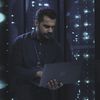 Person in datacenter holding a laptop.