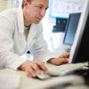 Hyland Healthcare customer uses a desktop computer in a hospital setting.