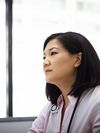 Clinician wearing a stethoscope against a blurred background.